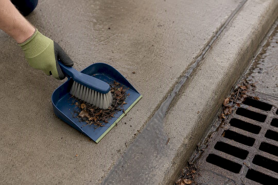 Sweeping wet debris away from storm drain